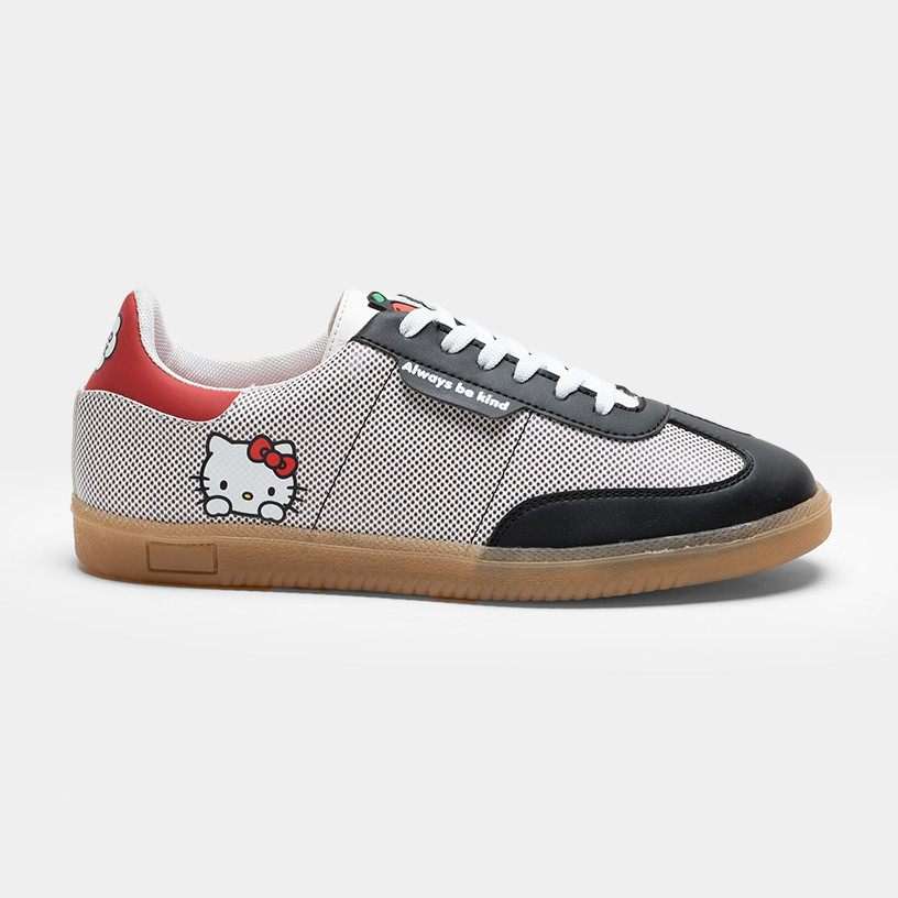 Vista lateral de tenis Hello Kitty retro para mujer en color gris y negro con suela de goma caramelo Vandeci.