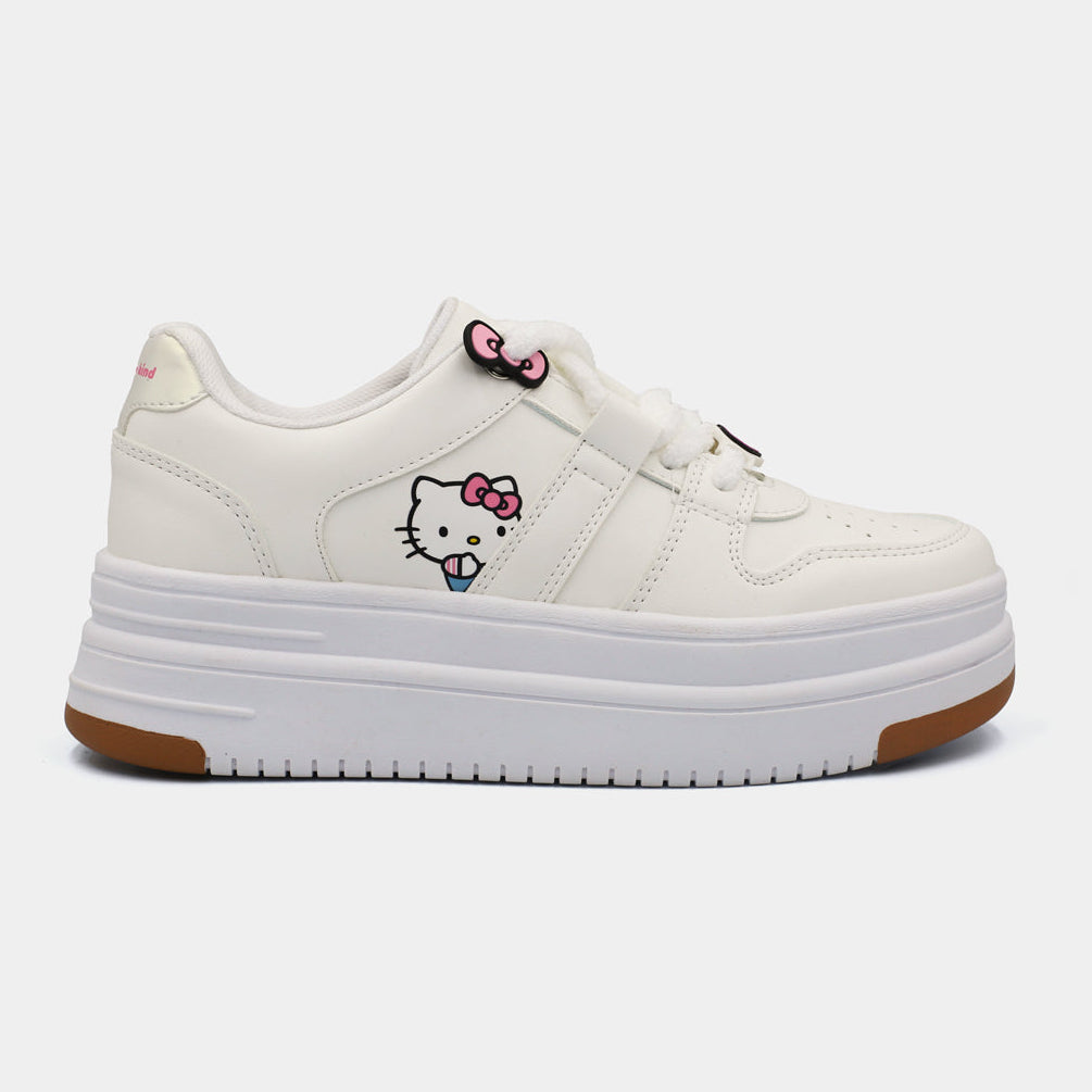 Tenis blancos con plataforma Hello Kitty, parche lateral del personaje y suela de goma color caramelo.