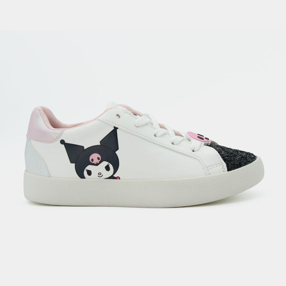 Tenis blancos de niña con estampado lateral de Kuromi, puntera con brillo negro y suela blanca plana.